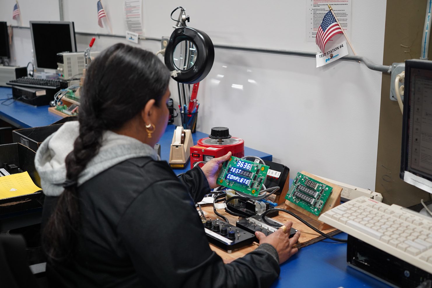 Testing Function of PCB Board Woman looking at results of run on power test
