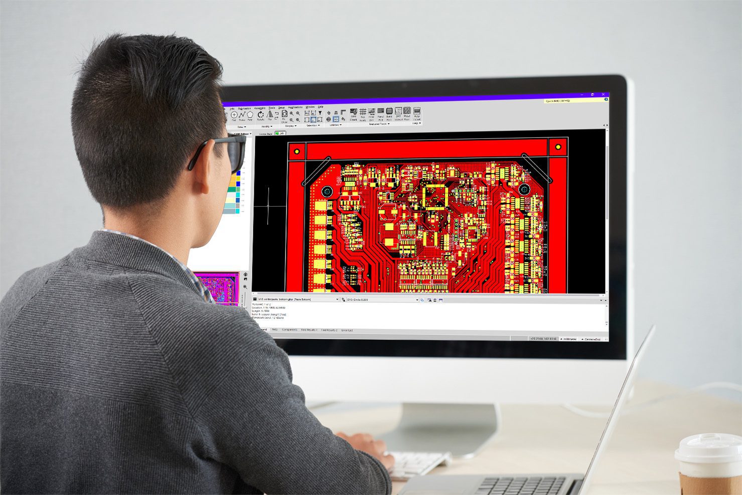 Laying out PCB board on computer Man at computer designing PCB board