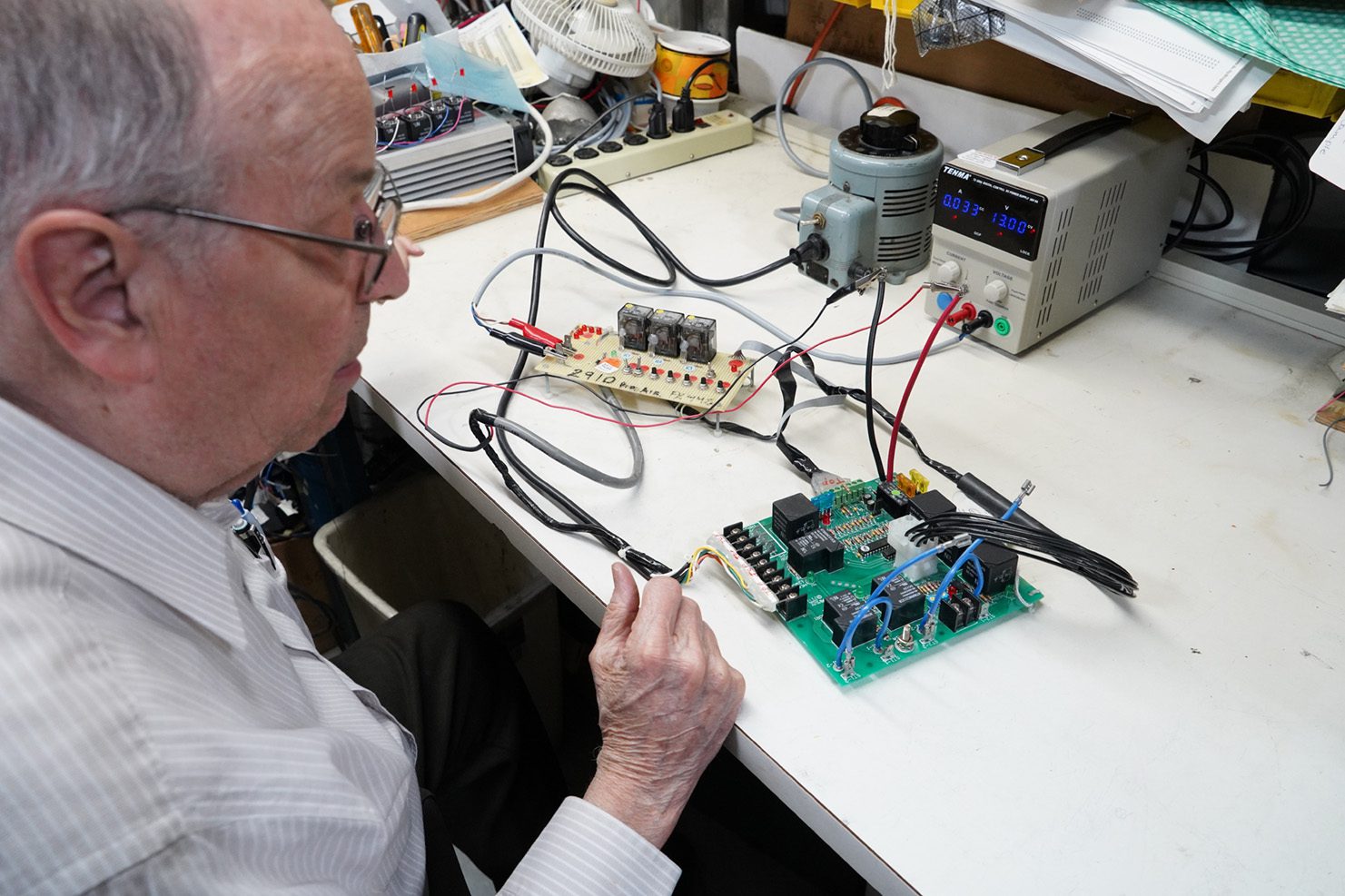 Developmental Testing PCB Prototypes Man testing PCB board for electrical output